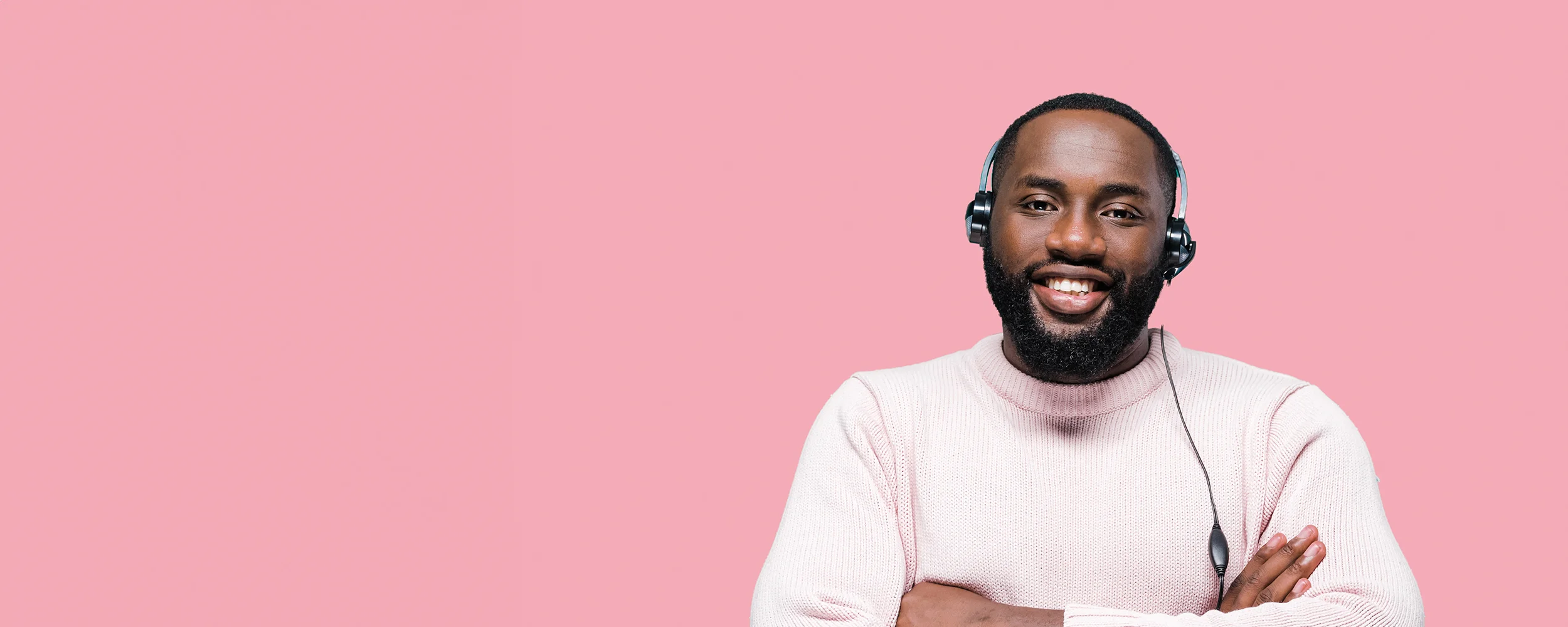 A male African American virtual receptionist on a pink background.