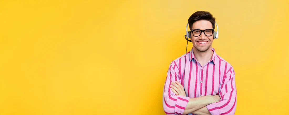 A male US Answering Service virtual receptionist on a yellow background.