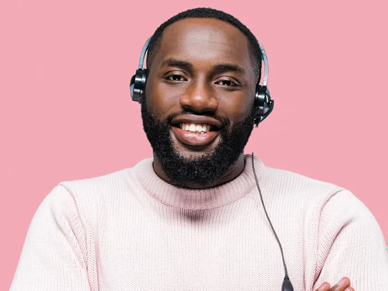 A male African American virtual receptionist on a pink background.