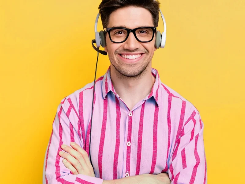 A male US Answering Service virtual receptionist on a yellow background.