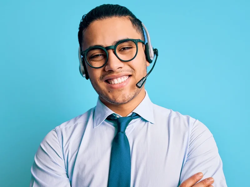 A male US Answering Service virtual receptionist on a blue background.