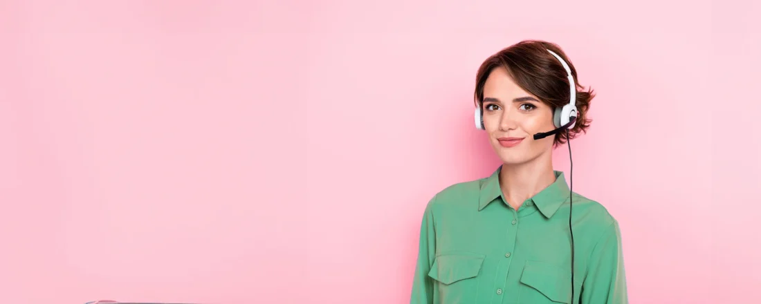 A female US Answering Service virtual receptionist on a pink background.