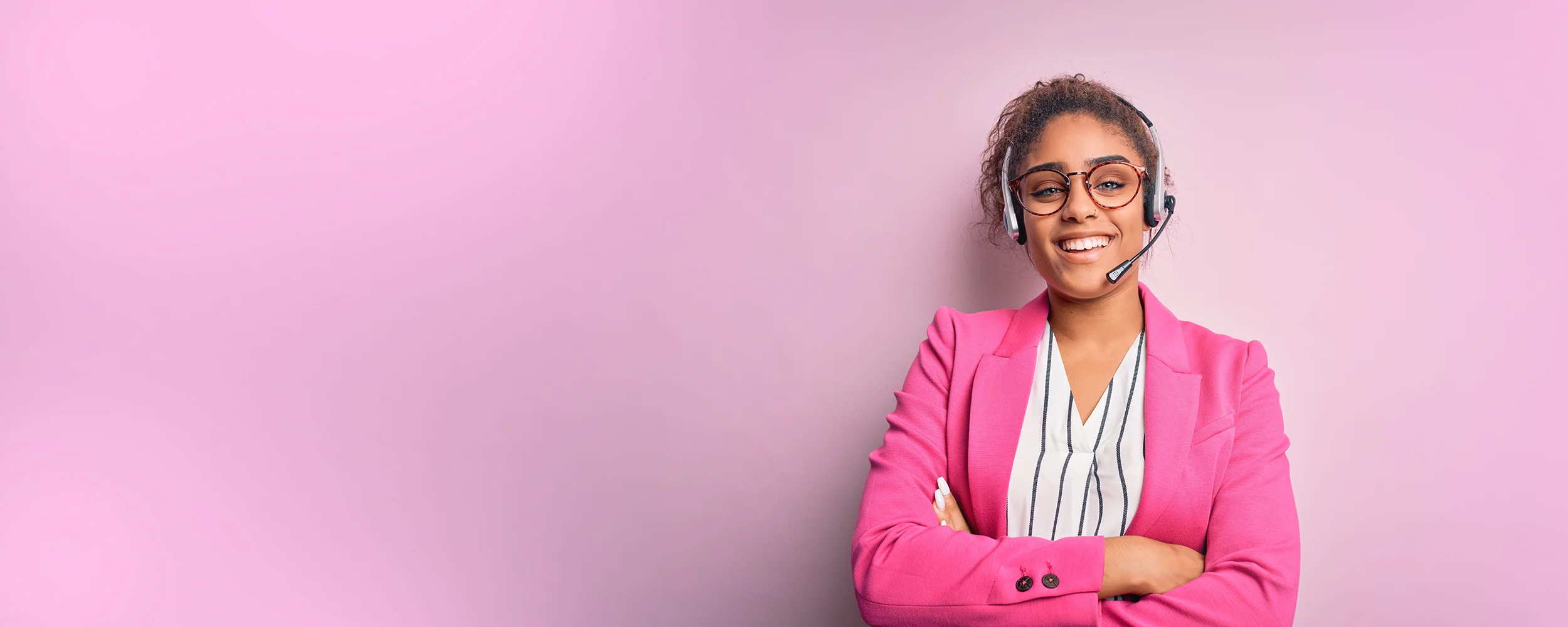 A female US Answering Service virtual receptionist on a pink background.